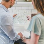 man and woman looking at tile designs