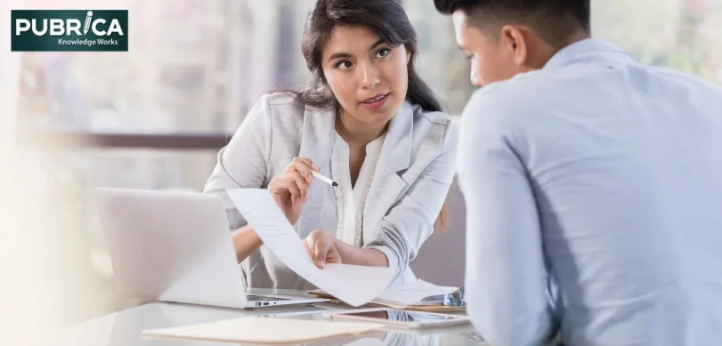 Researcher reviewing a manuscript with a colleague before journal submission