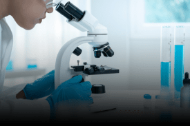 Medical professional conducting scientific lab research with microscope
