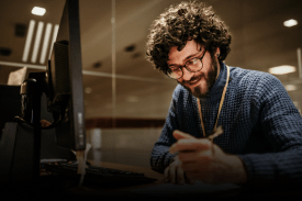 Non-native English author writing and editing manuscript at desk