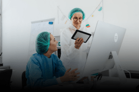 Pharmaceutical research scientists looking at computer workstation