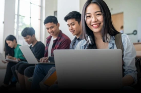 University students studying together on laptops