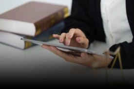 Independent consultant conducting research on a digital tablet
