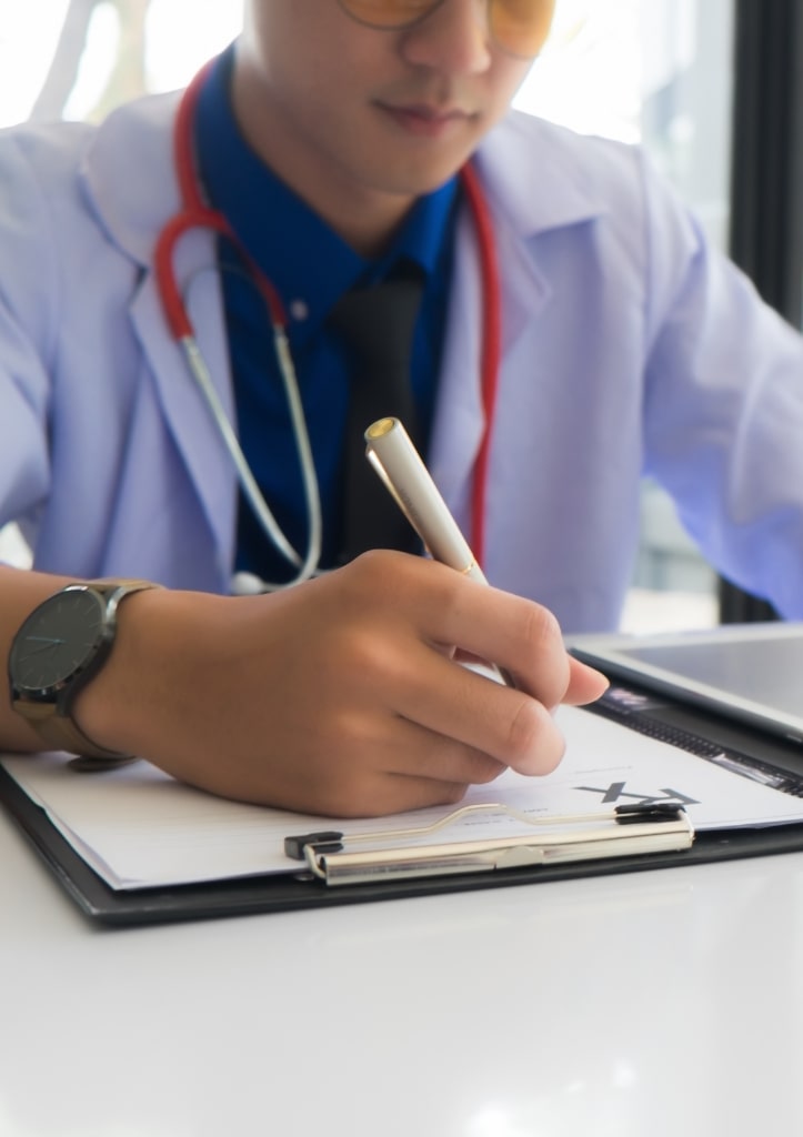 Doctor writing medical report and documentation