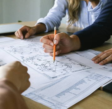 Reviewing technical blueprints and artwork
