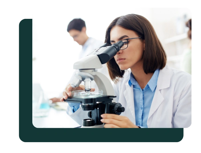 Scientist analyzing samples using a laboratory microscope
