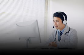 Independent consultant with headset working at desk