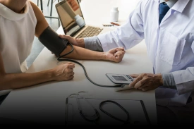 Doctor checking patient blood pressure with stethoscope